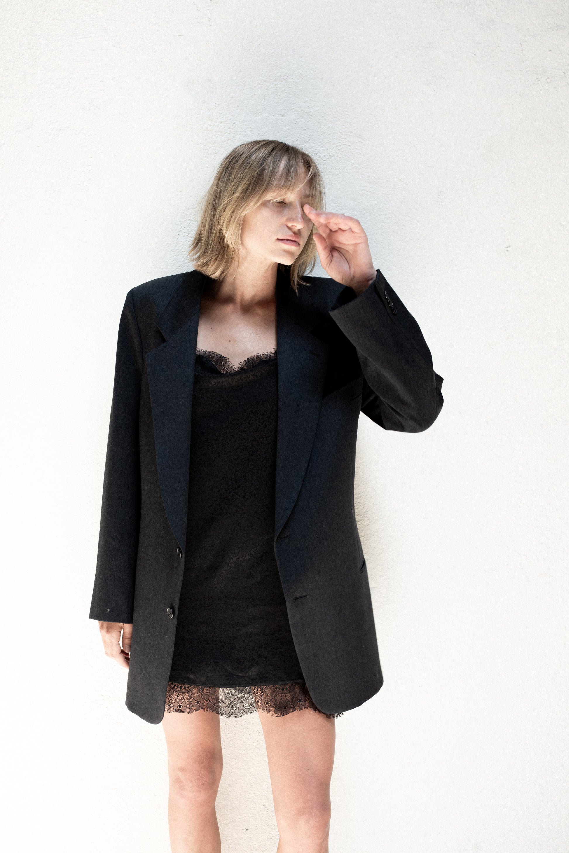 ADYELA Silk Slip Dress, showcasing a minimal silhouette, fluid 100% silk fabric draping, and a delicate hemline on a model